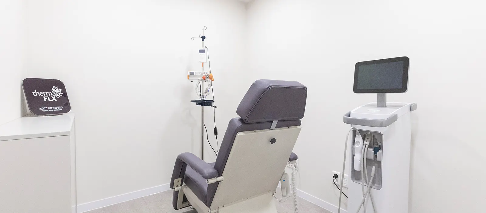 Procedure room with a treatment chair and Thermage FLX device