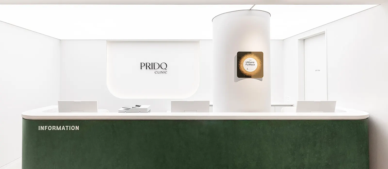 PRIDQ Clinic reception desk with the clinic logo and a green velvet counter