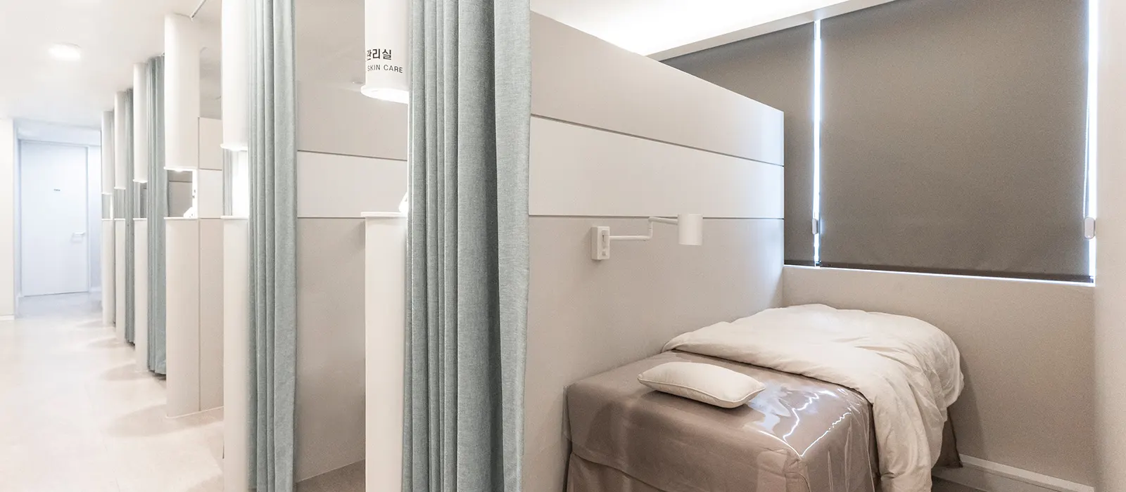 Skin care treatment area with curtained beds